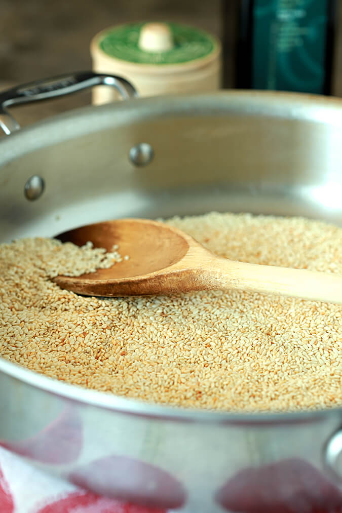 Tahini - a toasted sesame seed paste. Sesame seeds in a skillet browning for Tahini - Toasted Sesame Paste
