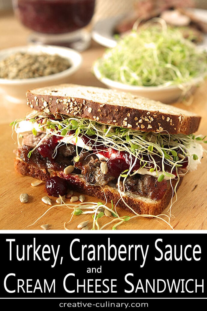Turkey Cranberry and Cream Cheese Sandwich with Sprouts and Sunflower Seeds on a Cutting Board