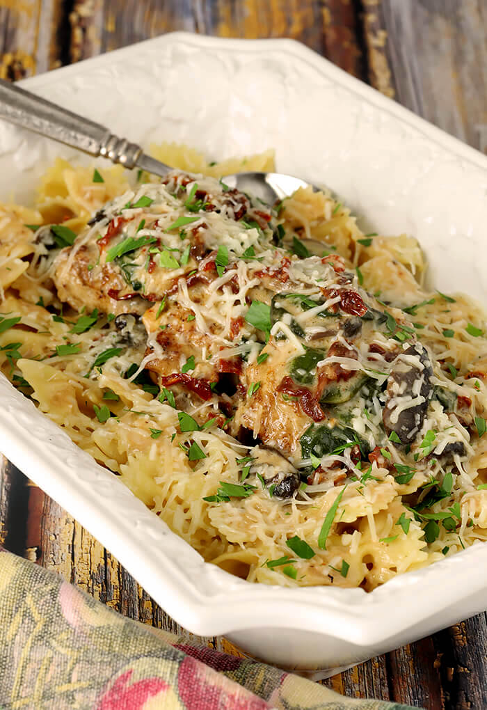 Tuscan Chicken in a White Rectangular Casserole Dish