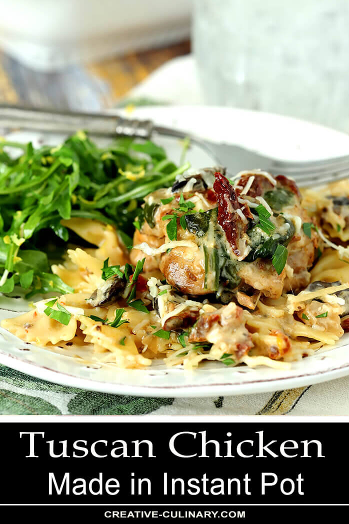Chicken with Mushrooms, Sun-Dried Tomatoes, and Spinach in a Cream Sauce over Noodles