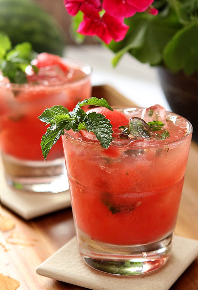Watermelon Mint Mojito Cocktails Watermelon Mint Mojito Cocktails are served in lowball glasses and garnished with mint.